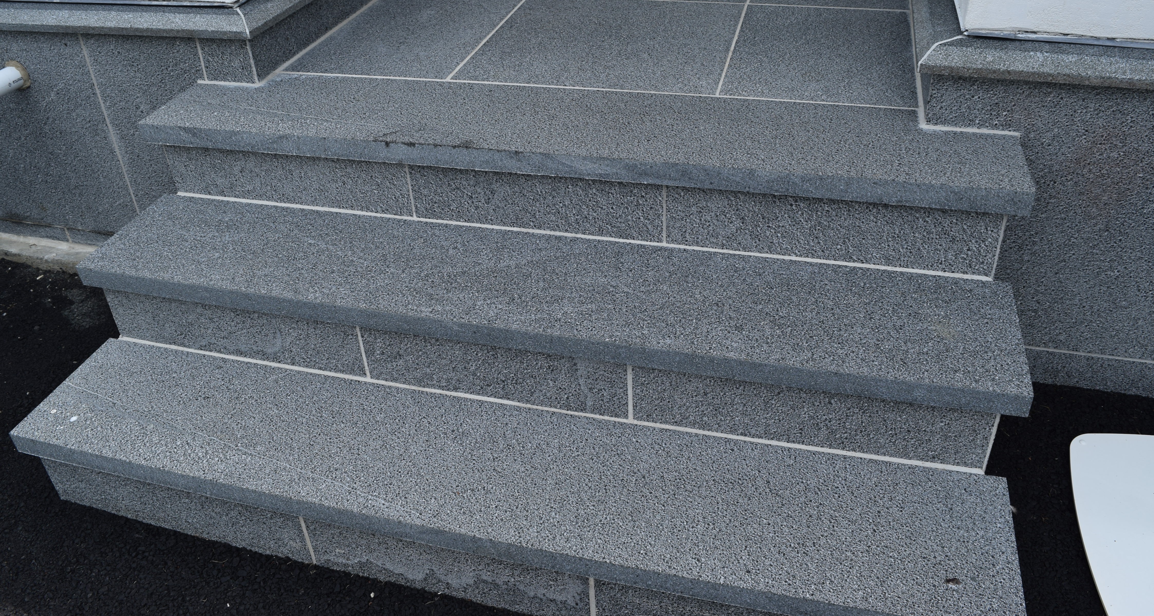 black moon sandblasted granite predominantly black with whit